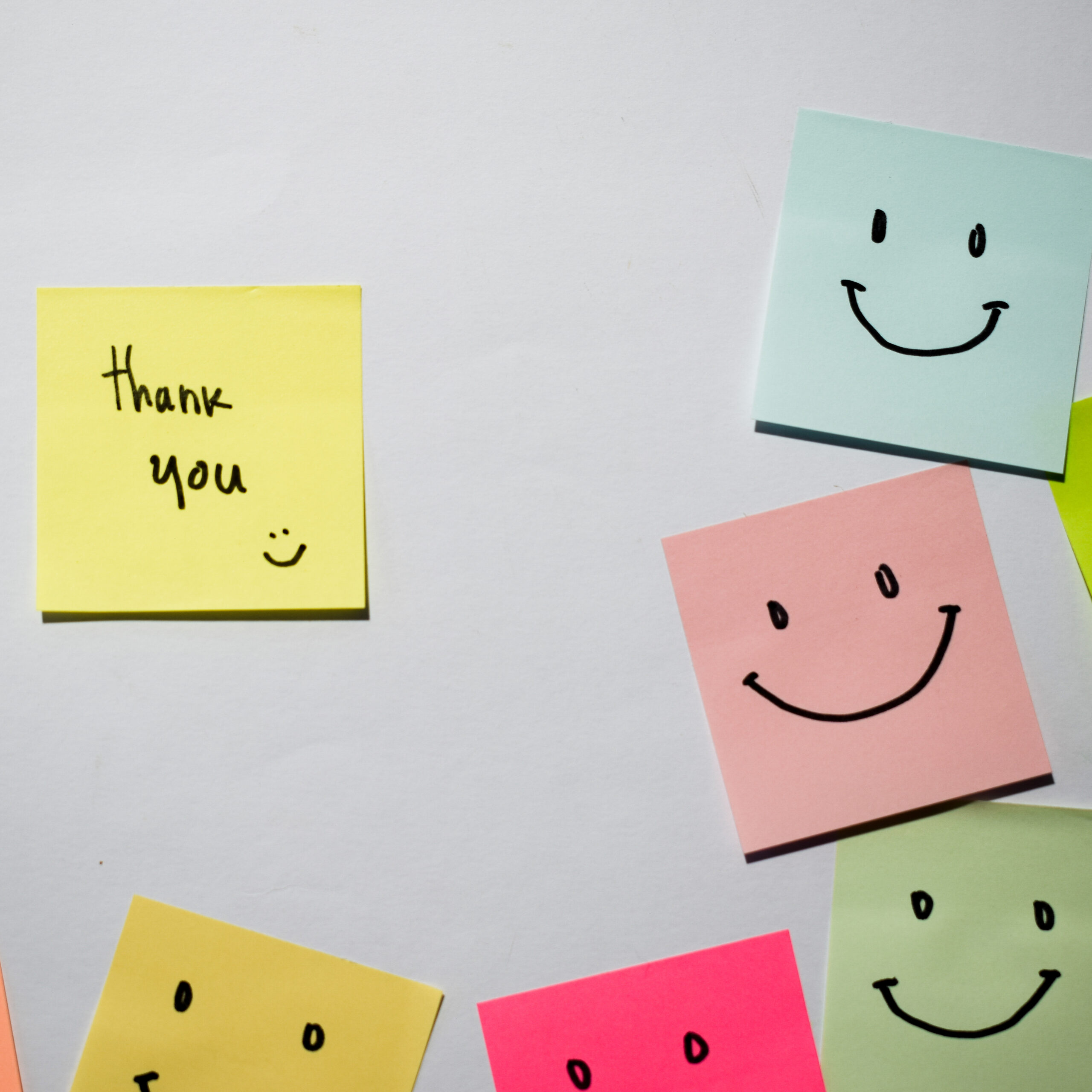 Thank you and smile emoticon on sticky notes. Motivational for p Thank you and smile emoticon on sticky notes. Motivational for personal development, inspirational handwriting. Isolated background